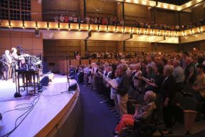The audience at Garrison Keillor’s Prairie Home Companion sing along. May 2, 2015. Photograph by Brian Yoder Schlabach. (https://www.goshen.edu/wp-content/uploads/sites/11/2015/05/15_APrairieHomeCompanion_031_bys-1366x911.jpg)