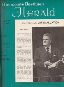 A magazine cover. It is an emerald green color and features the words "Mennonite Brethren Herald" in white at the top of the page. In the middle of the page is a white box with text, featuring an image of Billy Graham speaking to an audience while holding an open Bible.